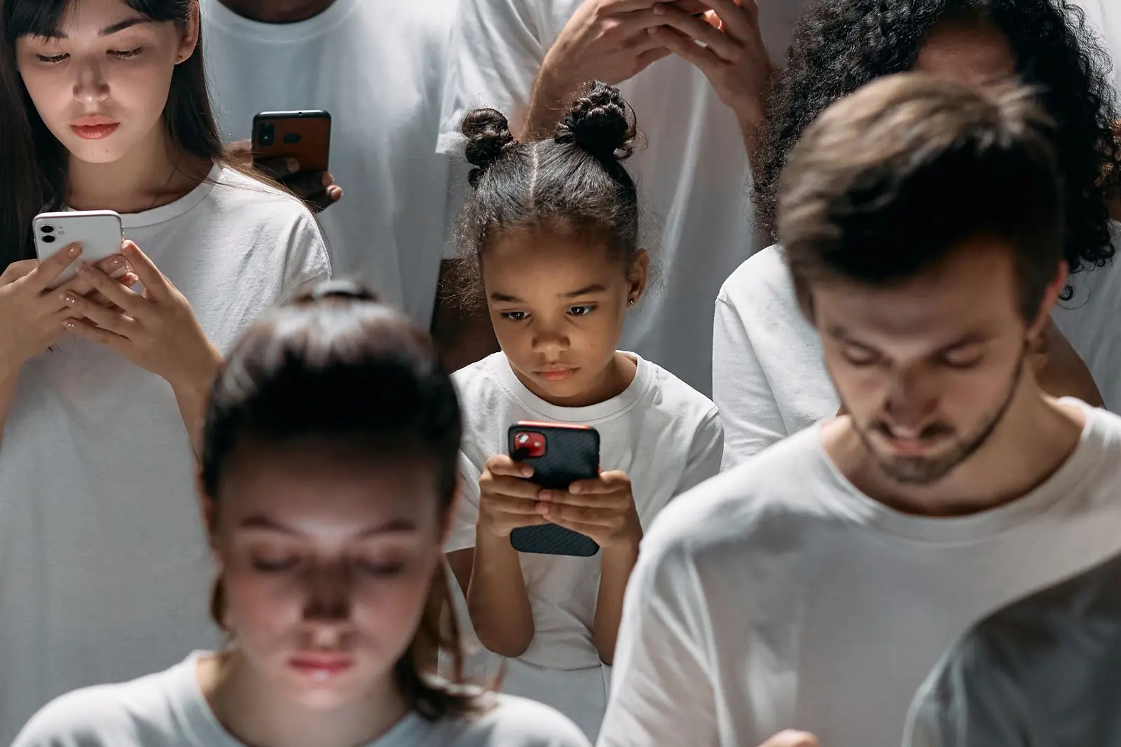 Group of people absorbed in their smartphones