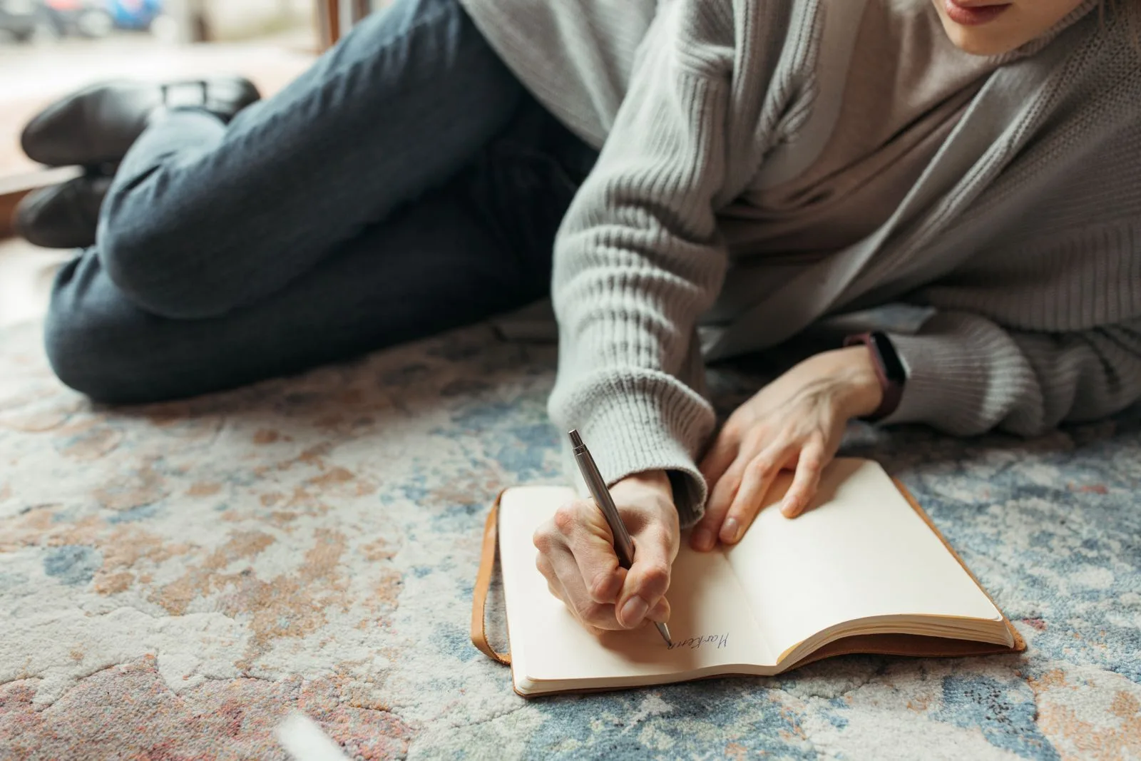 Close-up of an adult writing in a journal by hand with a pen, a calm replacement for scrolling