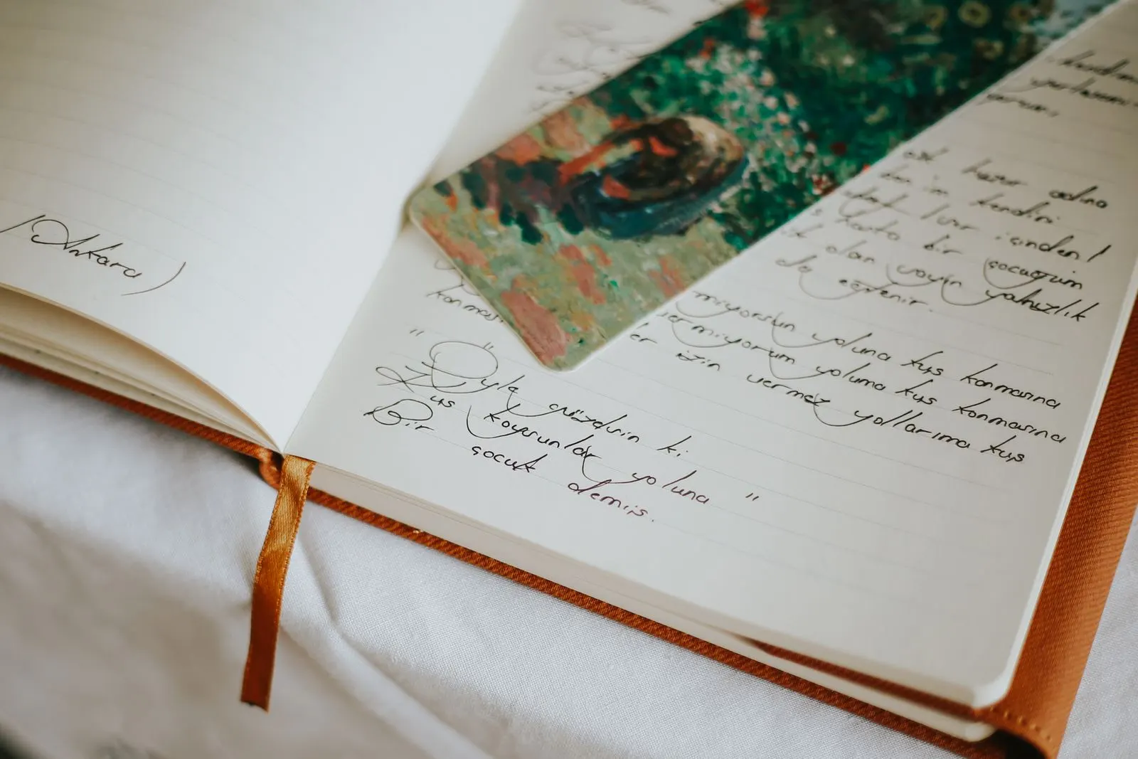 Open journal with handwritten notes and a bookmark