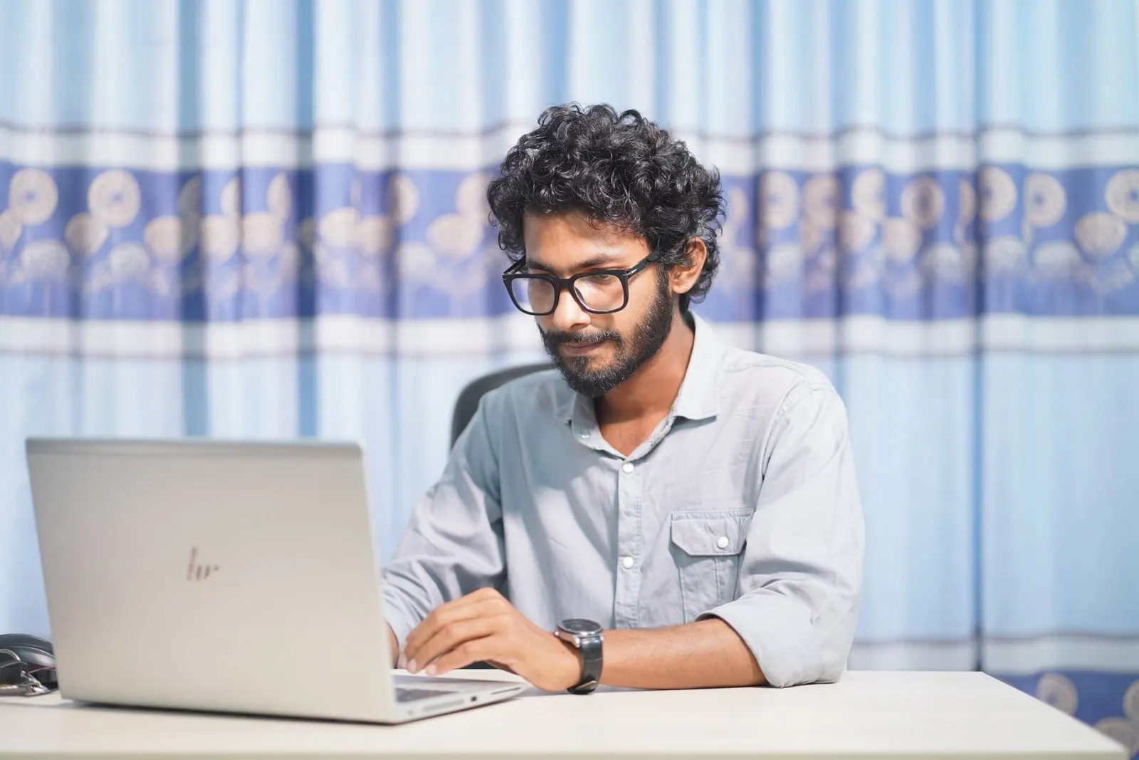Person focused on a laptop while working without distractions