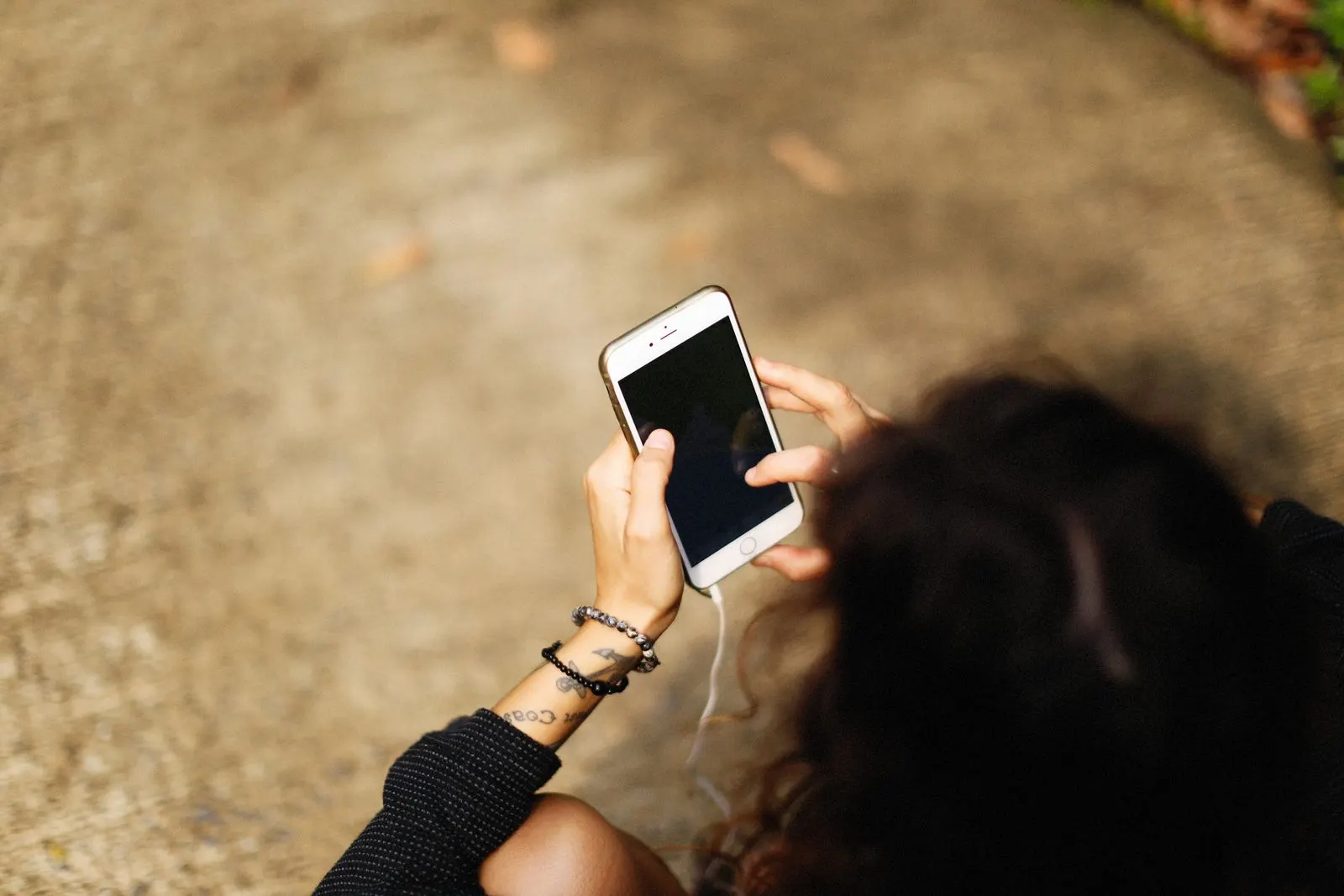 Person holding a smartphone and checking screen time